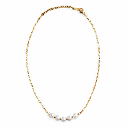 A delicate gold chain necklace with five faceted white beads spaced along the lower center, displayed on a clean white background.
