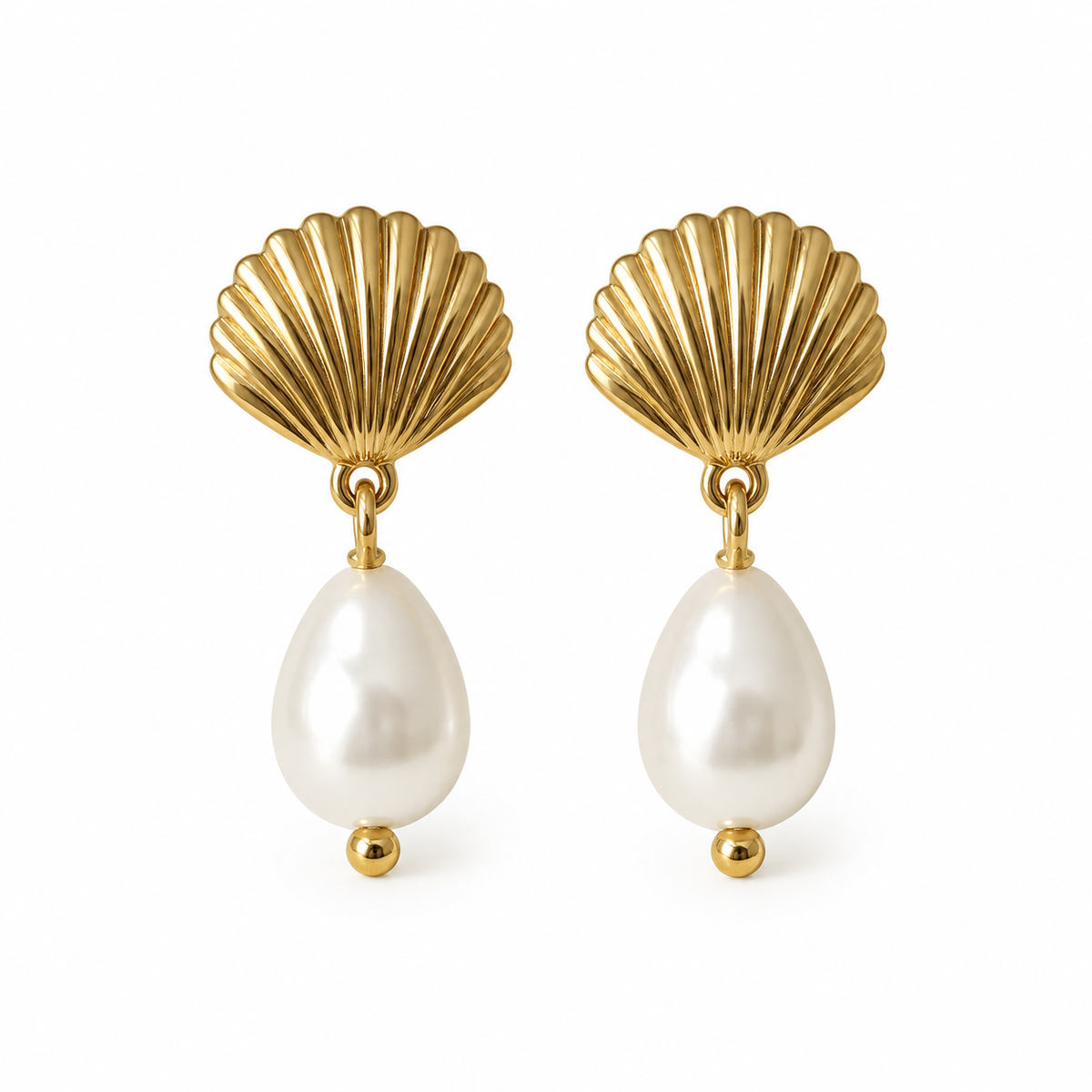 A pair of gold shell drop earrings with teardrop-shaped white pearls hanging below, set against a plain white background.