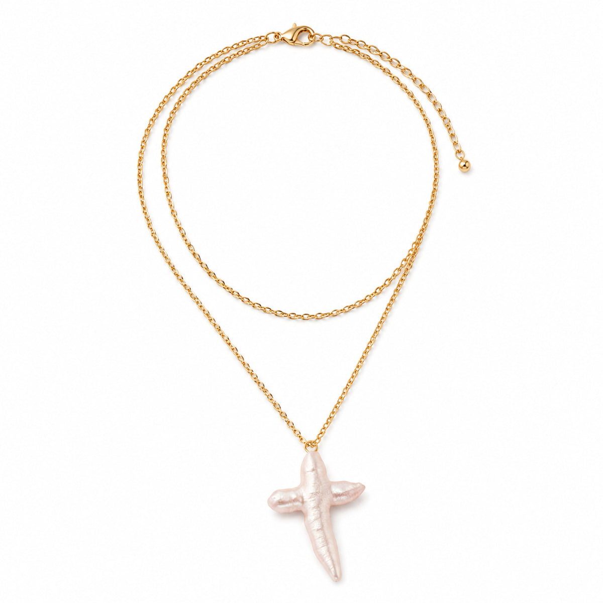 A double-layered gold chain necklace featuring a textured, pale pink cross pendant, displayed on a clean white background.