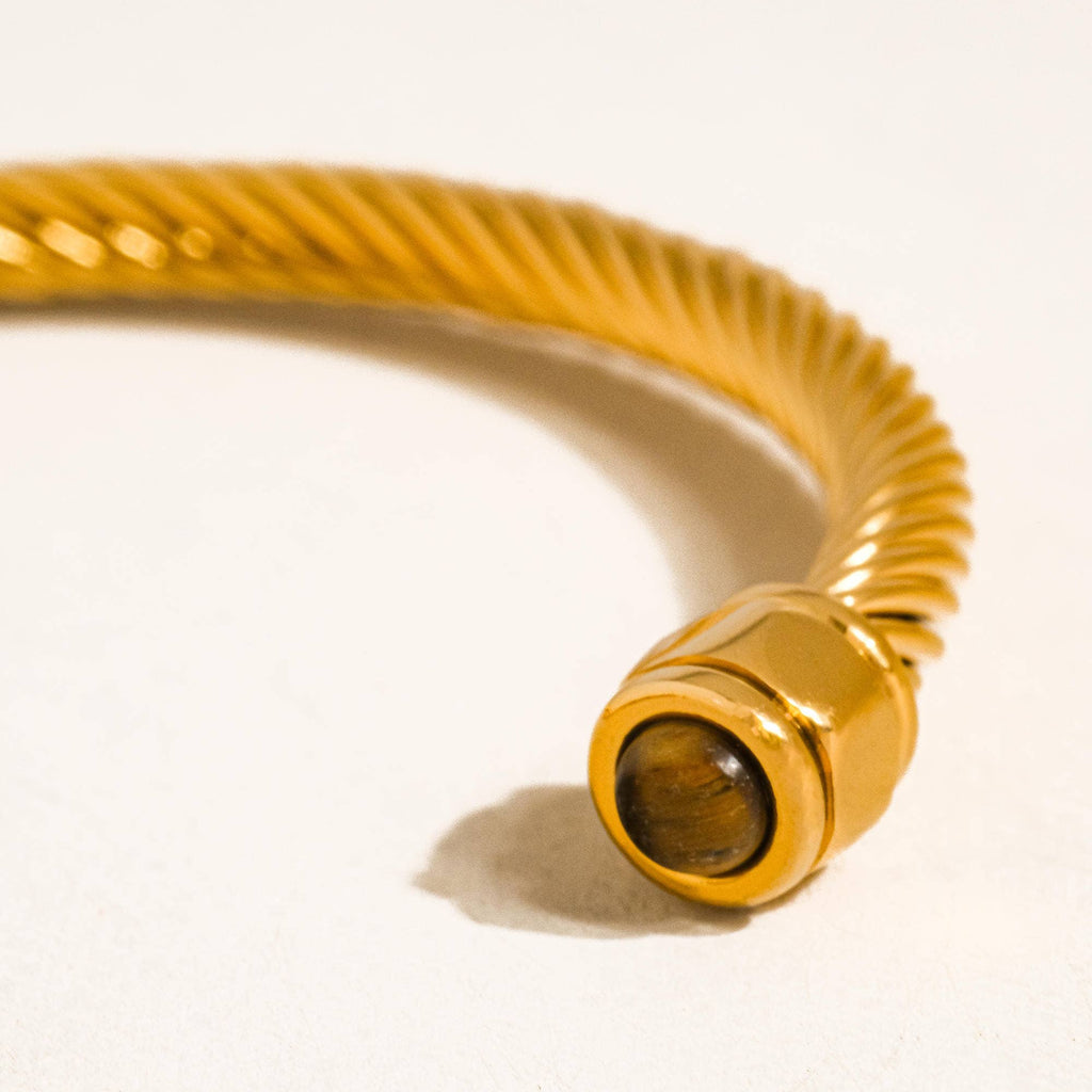 Gold-colored hose with a brown end on a white background