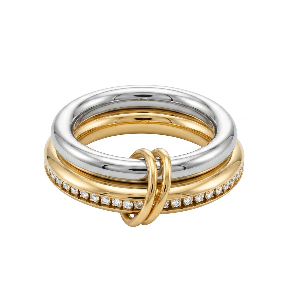 A two-tone yellow gold and silver ring stack featuring a central knot-like gold loop, a silver band with a row of small clear stones, and three polished gold bands, shown on a plain white background.