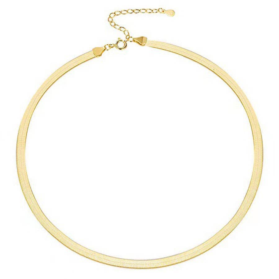 gold herringbone necklace on white background