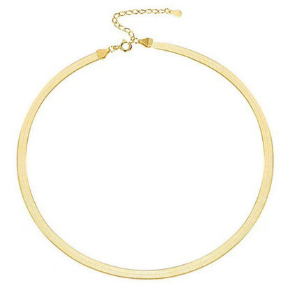 gold herringbone necklace on white background